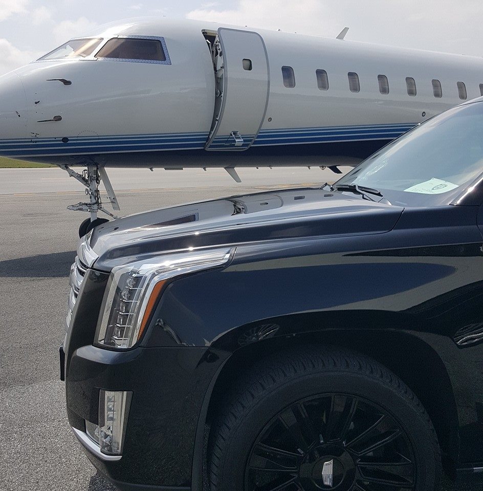 Cadillac Escalade parked at private FBO terminal for VIP airport transfers