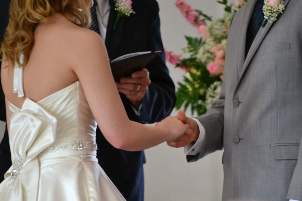 Bride and groom holding hands during a romantic wedding ceremony